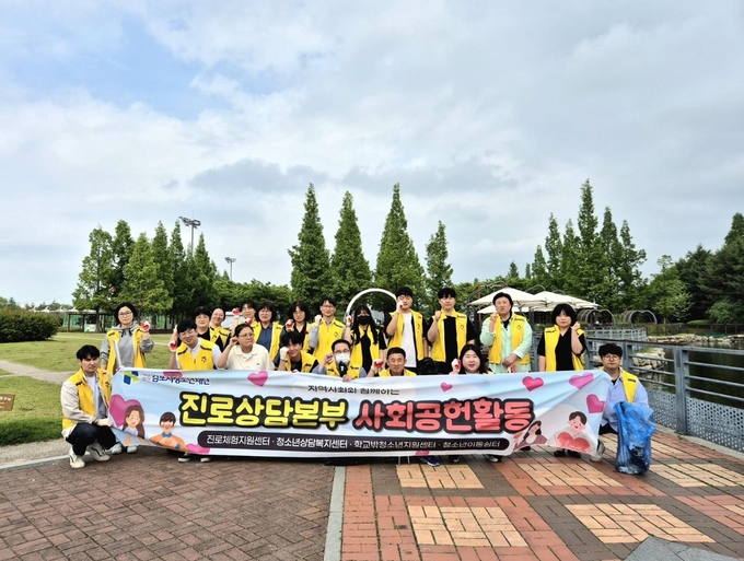 (재)김포시청소년재단 청소년진로상담본부 직원들이 중앙공원에서 환경정화 활동을 마친 뒤 기념사진을 찍고 있다. (사진=청소년진로상담본부 제공)