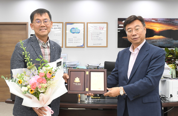신상진 성남시장이 지난달 20일 분당판교청소년수련관 수영장에서 물에 빠져 의식을 잃은 10대 박모 군을 인공 호흡으로 구조한 김재광 의사(왼쪽)에게 감사패를 전달했다. (사진=성남시 제공)