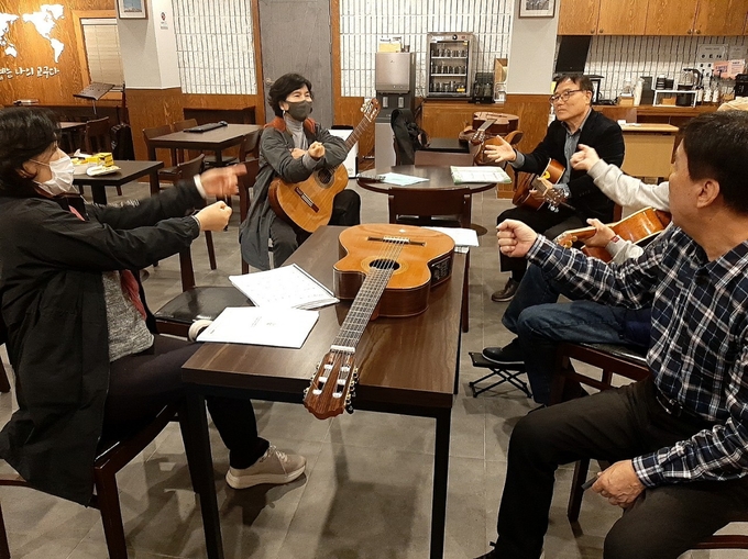 소모임 ’어울림‘이 부천시의 찾아가는 배달강좌 ’똑‘ 사업을 통해 ’즐거운 기타 강좌‘를 수강하고 있다. (사진=부천시 제공)