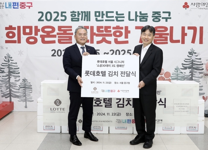 권정근 롯데호텔 서울 총지배인(왼쪽)과 이상훈 중구 부구청장이 배추김치 기부 전달식에서 기념 촬영을 하고 있다. (사진=롯데호텔 제공)