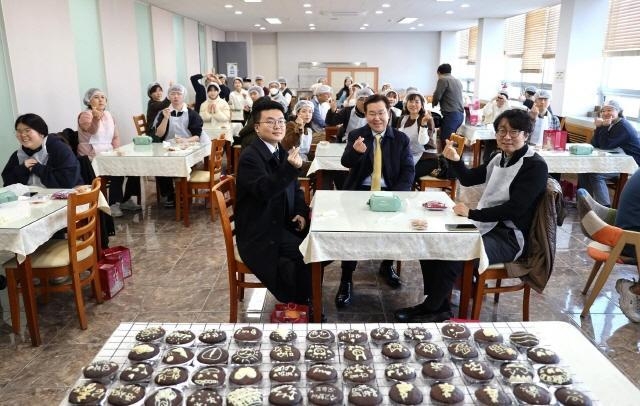 장광수(맨앞 테이블 가운데) 안양대총장이 4일 교직원식당에서 초코파이 나눔 봉사활동을 한 뒤 참가자들과 기념촬영을 하고 있다. (사진=안양대 제공)