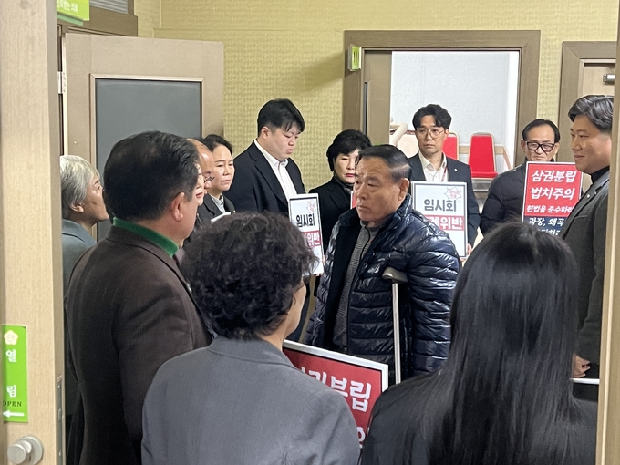 24일 수원시의회 제389회 임시회 개의 전 피켓시위를 진행한 국민의힘 의원들과 이재식 수원시의회 의장이 충돌하고 있다. (사진=장진 기자)