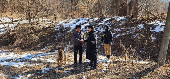  안산 수암산에서 구조된 치매노인 A씨와 체취 증거견 테오. (사진=경기남부경찰청 제공)