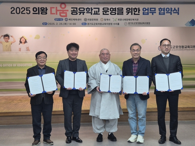 성정현 군포의왕교육지원청 교육장(왼쪽 네 번째)과 4개 운영 기관 대표자들이 업무 협약 체결서를 들어보이고 있다. (사진=교육지원청 제공)