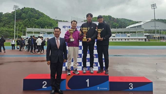 10일 가평군 가평종합운동장에서 열린 '제71회 경기도체육대회 2025 가평' 육상 1부서 1~3위에 입상한 시·군 관계자들이 전재범 경기도육상연맹 회장(왼쪽)과 기념사진을 찍고 있다. (사진=경기도육상연맹 제공)