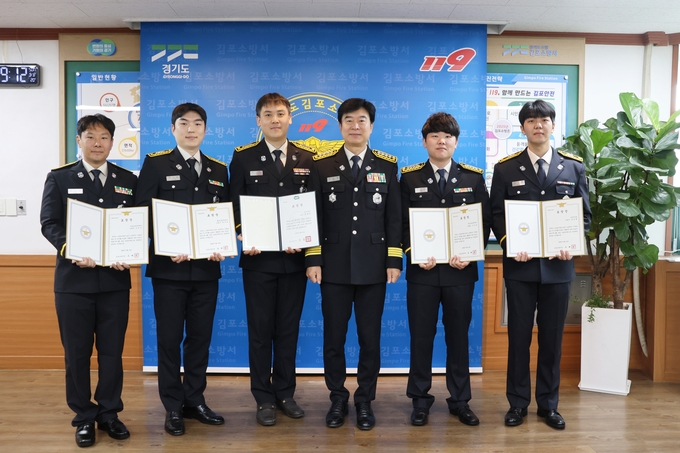 김포소방서의 이달의 모범 소방공무원으로 선정된 5명이 유해공 서장(오른쪽 3번쨰)으로 부터 표창을 받고 기념사진을 찍고 있다. (사진=김포소방서 제공)