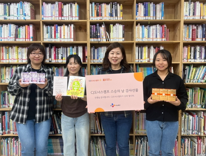 지난 13일 서울 성북구에 위치한 다솔지역아동센터 김은영 센터장(오른쪽에서 두 번째)을 비롯한 선생님들이 CJ도너스캠프가 준비한 스승의 날 감사 선물을 받고 환하게 웃고 있다. (사진=CJ 제공)