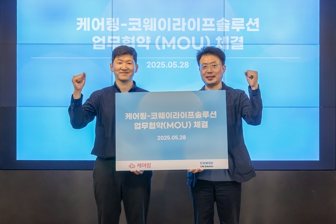 김명곤 코웨이라이프솔루션 대표이사(오른쪽)와 김태성 케어링 대표이사(왼쪽)가 기념 촬영을 하고 있다. (사진=코웨이 제공)