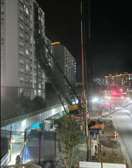 5일 오후 10시 13분쯤 경기도 용인시 기흥구 서천동 소재 인덕원~동탄 복선전철 공사 현장에서 중장비가 15층짜리 아파트 쪽으로 넘어졌다. (사진=경기소방본부 제공)