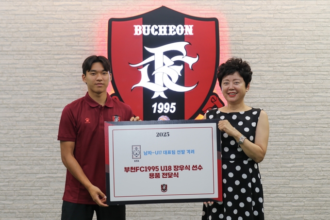 부천FC U18 장우식 선수가 축구용품 전달식 진행 후 김수경 이사장과 기념사진을 찍고 있다. (사진=부천FC1995 제공)