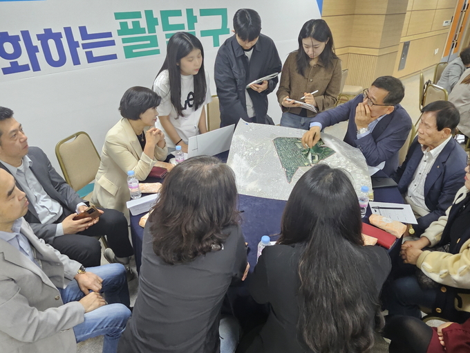 수원시 우리동네 자치계획 수립 워크숍에서 주민과 튜터진이 중장기 발전 계획을 수립하기 위해 머리를 맞대고 있다. (사진=수원시 제공)