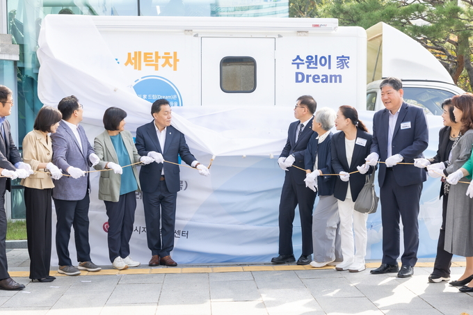 이재준(중앙 왼쪽) 수원특례시장과 장정희(중앙 왼쪽에서 두 번째) 수원특례시의회 기획경제위원장, 창성수(중앙 오른쪽) MG새마을금고 지역나눔재단 사무국장을 비롯해 자원봉사단체장들이 '찾아가는 세탁차' 제막식을 하고 있다. (사진=수원시 제공)