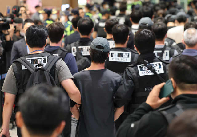 캄보디아 온라인 사기에 가담해 구금된 한국인들이 18일 오전 인천국제공항 제2터미널을 통해 송환되고 있다. 이날 송환에는 경찰 호송조 190여명이 투입됐다. (사진=연합뉴스 제공)