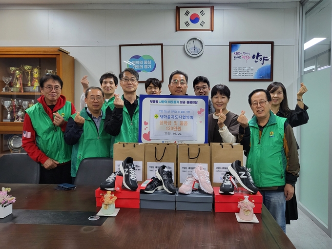 한윤희(앞줄 가운데) 안양시새마을지도자부흥동협의회장이 부흥동행정복지센터에 장학금 등을 기탁한 뒤 관계자들과 기념촬영을 하고 있다. (사진=안양시새마을회 제공)