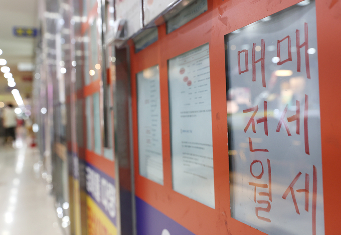지난 5일 서울 송파구 부동산중개업소 매물 정보란앞으로 한 시민이 지나가고 있다. (사진=연합뉴스)